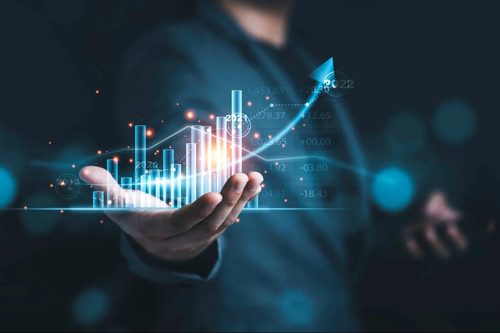 A projected growth chart above an outstretched hand